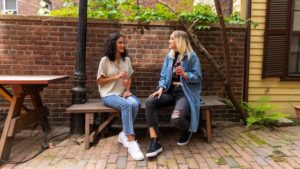 Two women sitting down and talking