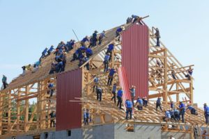 Workers working together to build a house