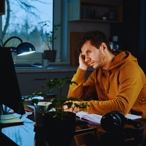 man procrastinating on what to do